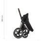Baby stroller with black seat and canopy, black frame, and large front wheels