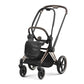 Stroller with black seat and canopy, black frame with rose-gold trim, front wheels