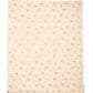 Quilt with cream base and small pink floral pattern, folded corner visible
