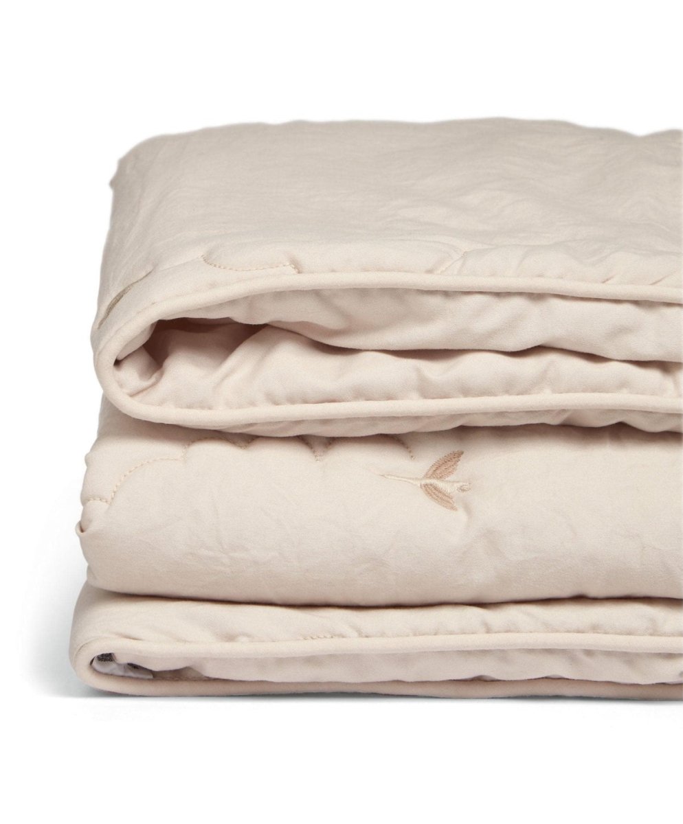 Soft taupe baby quilt folded stack with stitched border and small motif details