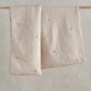 Soft taupe baby quilt, two folded panels with tiny stitched star motif details