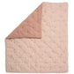 Light pink quilt blanket with diamond stitching and scattered small floral embroidery