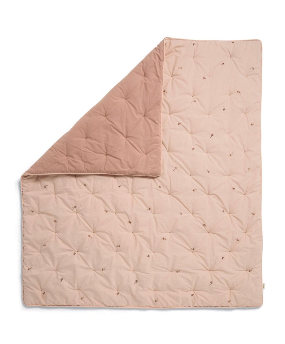 Light pink quilt blanket with diamond stitching and scattered small floral embroidery
