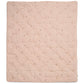 Light pink quilt blanket with quilted diamond pattern and scattered small floral motifs