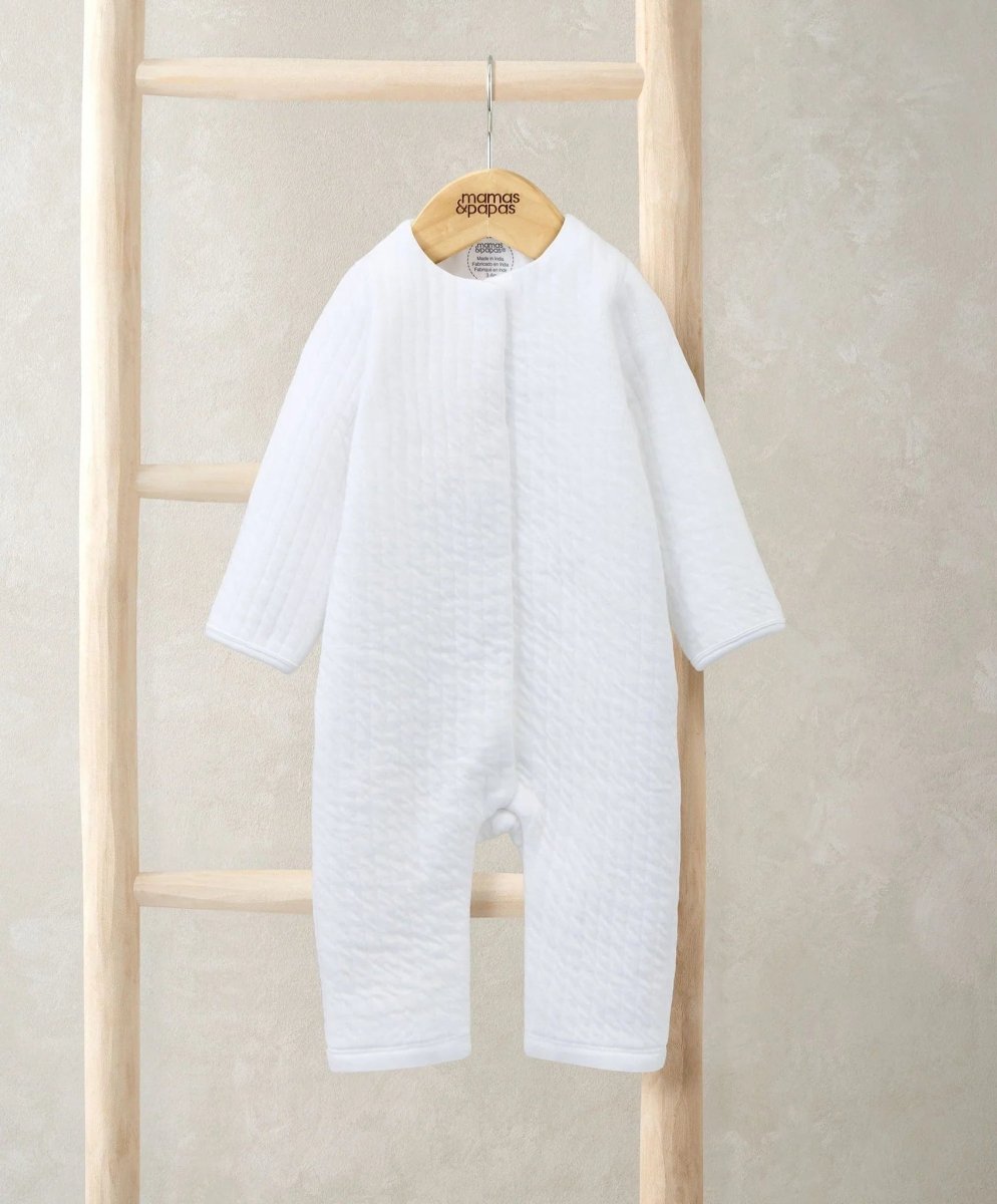 White quilted romper with long sleeves and crew neckline