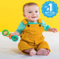 Barbell rattle toy in baby’s hands, turquoise and green end discs with bead-filled center