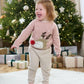 Pink reindeer Christmas jumper on child, long sleeves with reindeer face applique