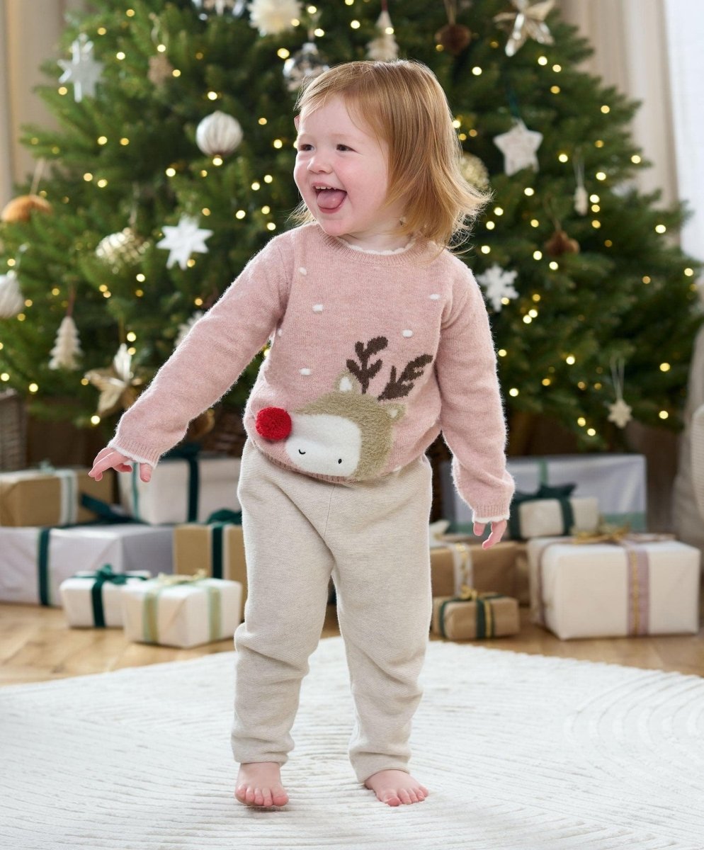 Pink reindeer Christmas jumper on child, long sleeves with reindeer face applique
