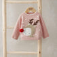 Reindeer Christmas jumper in dusty pink, full front view with pom-pom and knit pattern