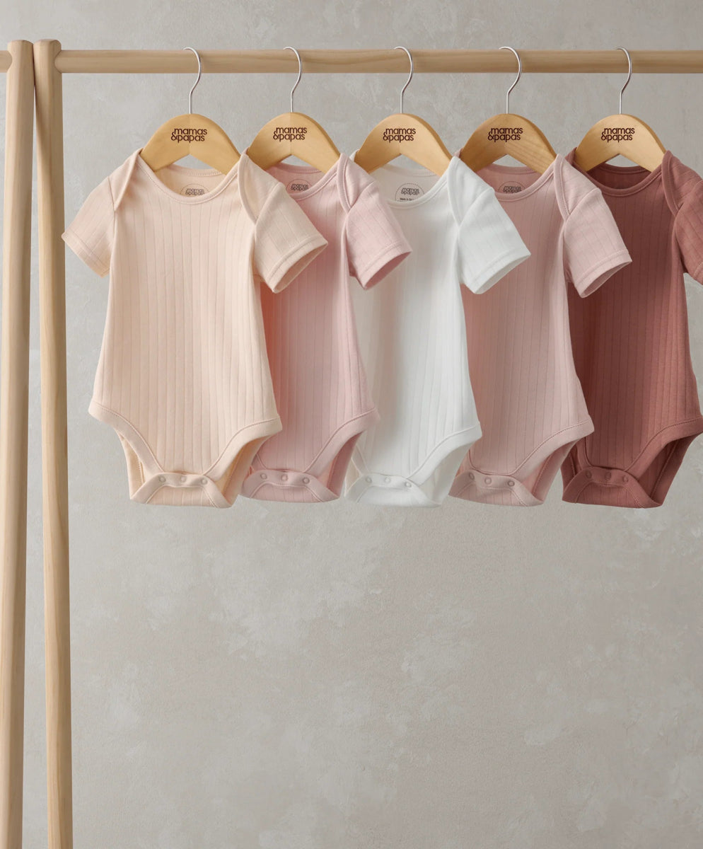 Hanging ribbed short-sleeve bodysuits, mix of white and blush pink shades, crew neck