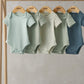 Ribbed short-sleeve bodysuits set (5) on hangers, mint, cream, and blue shades