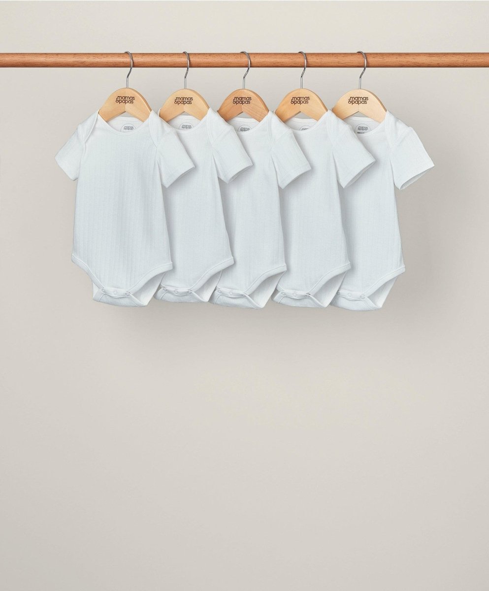Set of 5 white ribbed short-sleeve bodysuits with snap crotch, hanging