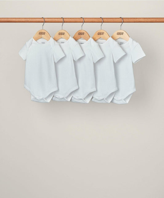 Set of 5 white ribbed short-sleeve bodysuits with snap crotch, hanging
