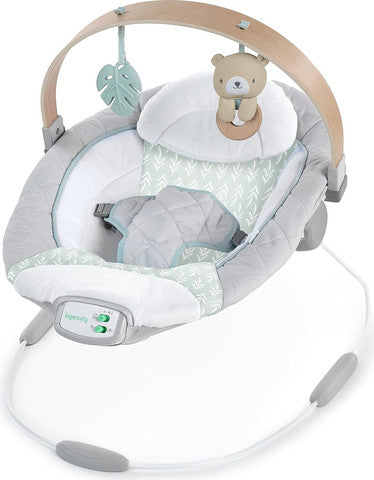 Portable baby swing with white and mint fabric, plush bear toy on wooden arch