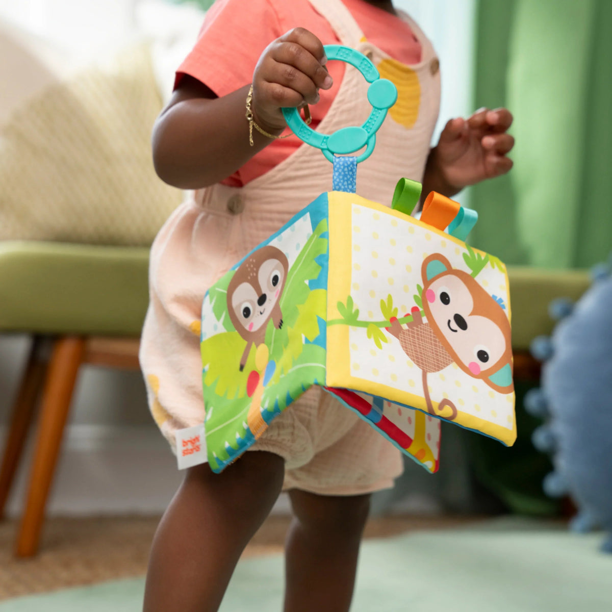 Soft cloth baby book with two safari animals on fabric pages and teal handle ring