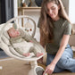 2-in-1 baby swing rocker in gray with white frame, baby lying and caregiver adjusting
