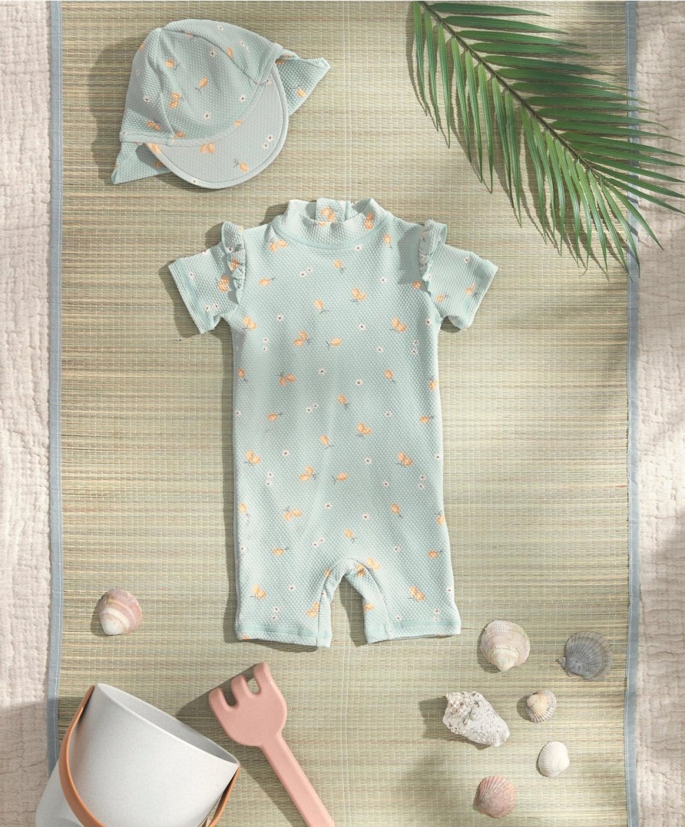 Light blue short-sleeve rashguard swimsuit with allover lemon print