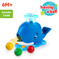 Blue whale ball popper toy with light-up spout and three included colorful balls