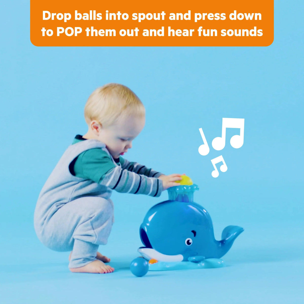 Blue whale ball popper toy with light-up spout and colorful balls on base
