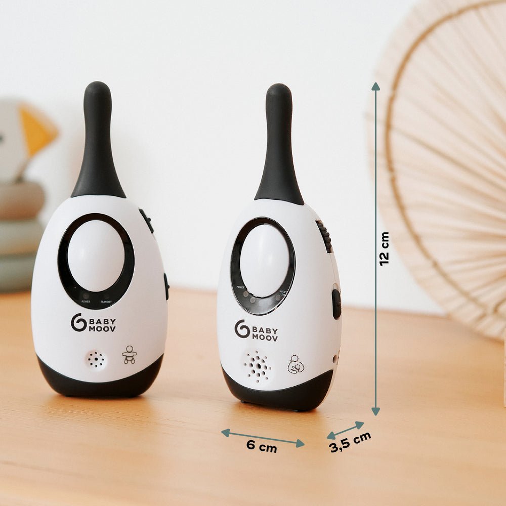 Baby monitor adapter, white body with dark top and oval display; two standing units