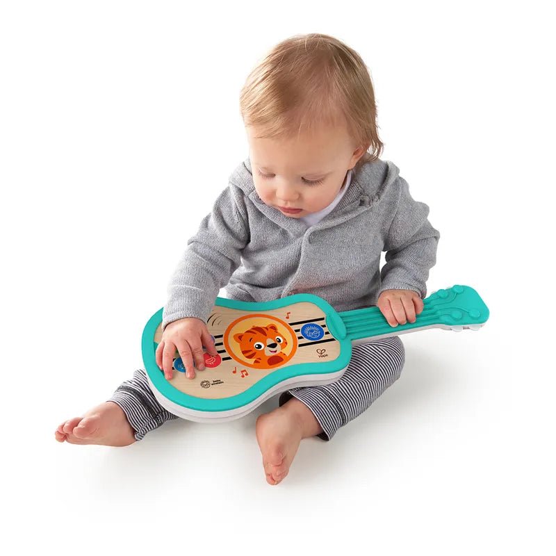Teal plastic kids guitar toy with lion face graphic and colorful buttons