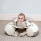 Plush baby floor seat with front play tray, baby sitting in a light gray cushion