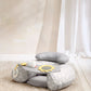 Gray and white infant play seat with cloud and star plush toys on cushion