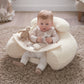 Cream plush duckling sit-and-play seat with attached dangling star and toy