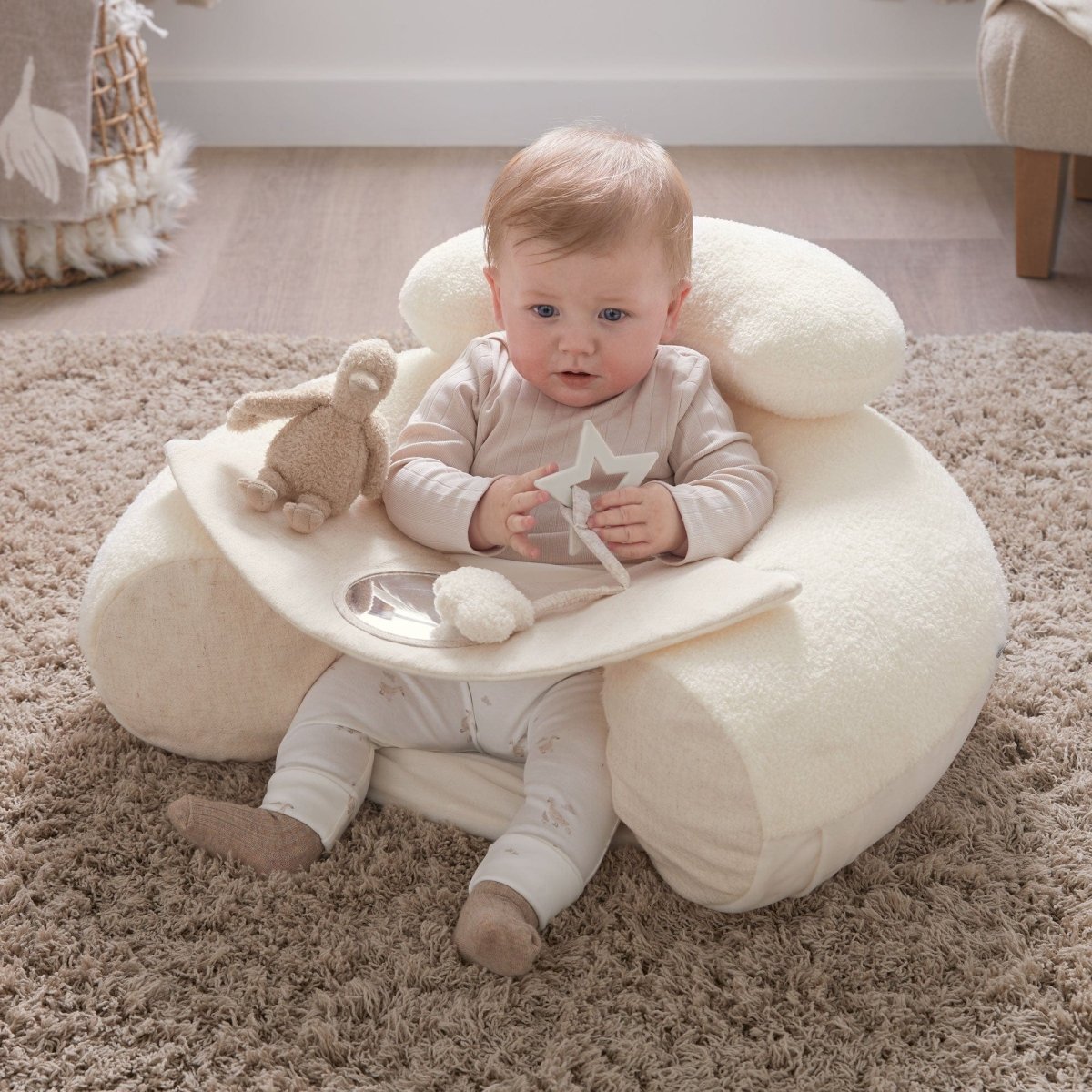 Cream plush duckling sit-and-play seat with attached dangling star and toy
