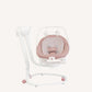 White and pink baby swing with tall backrest and arched base, hanging toy attachments