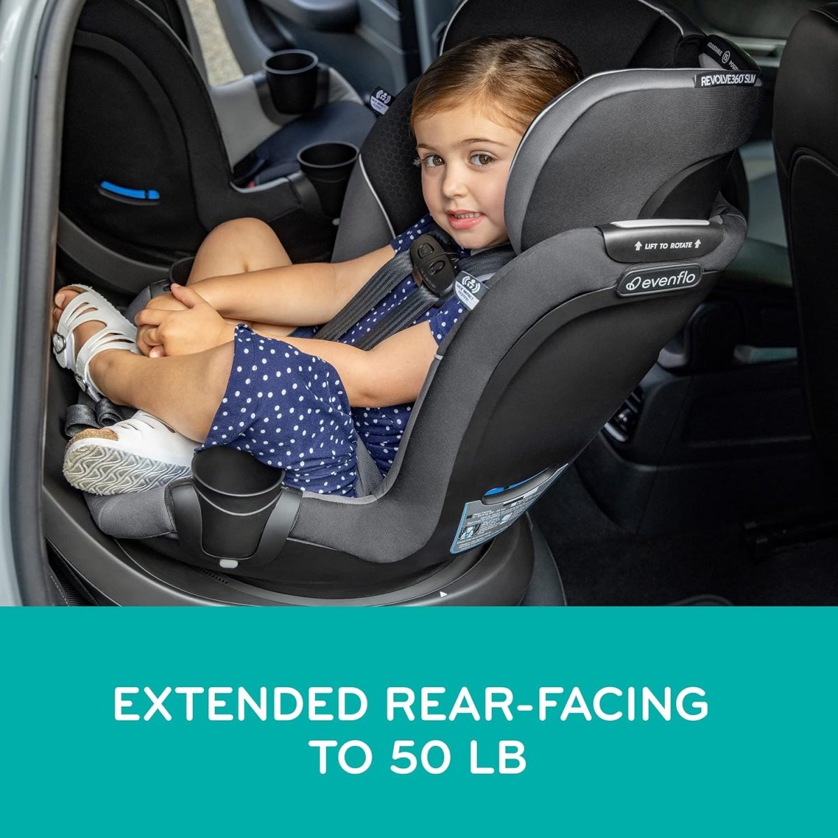Rotational convertible car seat with cushioned sides and blue-accented harness