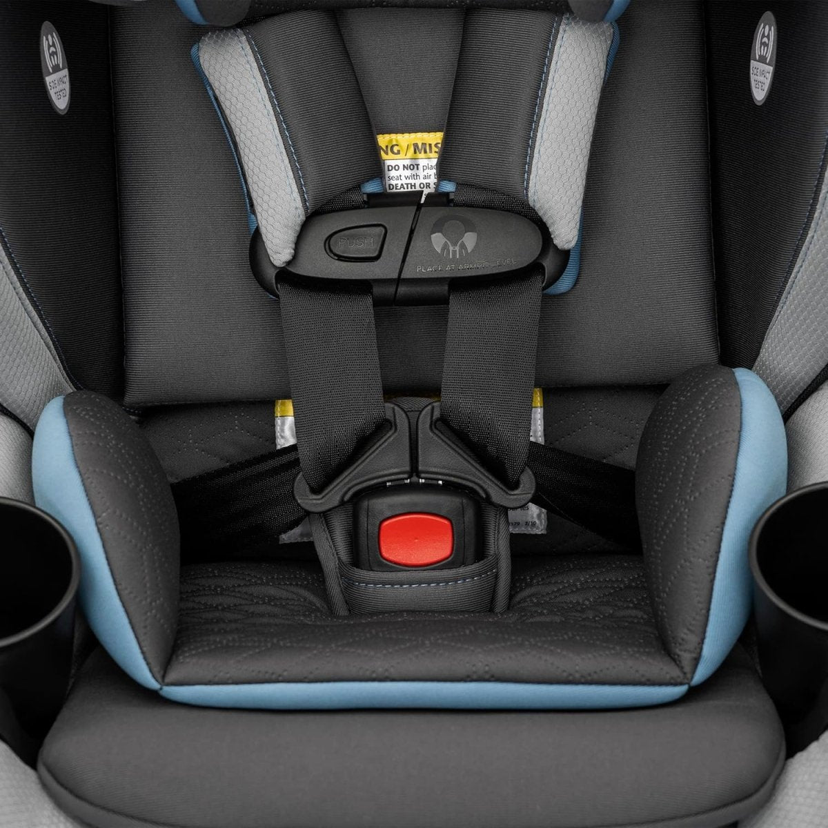 Rotational convertible car seat with harness straps and red buckle release button