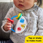 Baby holding a colorful 3-piece musical toy with chime buttons