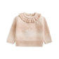 Light beige kids' snowflake knit jumper, ruffled high neck, long sleeves (flat lay)