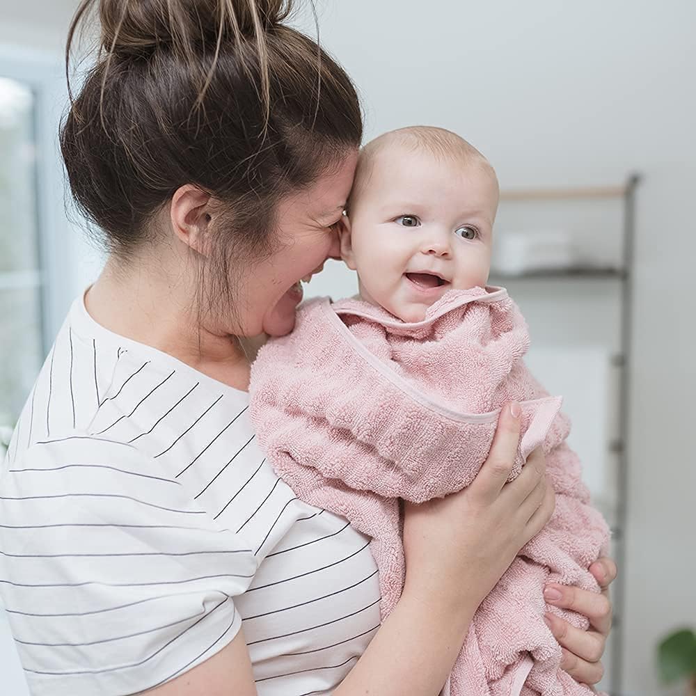 Pink baby bath support with soft-touch perforated insert, curved cradle