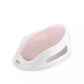White baby bath support with pink soft-touch perforated insert and curved base