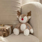 Plush reindeer soft toy with brown antlers and white belly, sitting on a chair