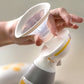 Breast pump bottle and funnel with white body and clear shield, yellow trim
