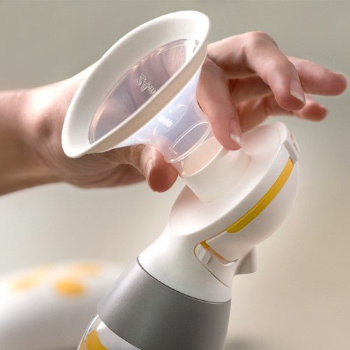 Breast pump bottle and funnel with white body and clear shield, yellow trim