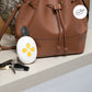 Round breast pump controller with yellow buttons and dark strap, white shell