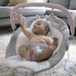 Infant reclining in gray and pink bouncer on a soft rug