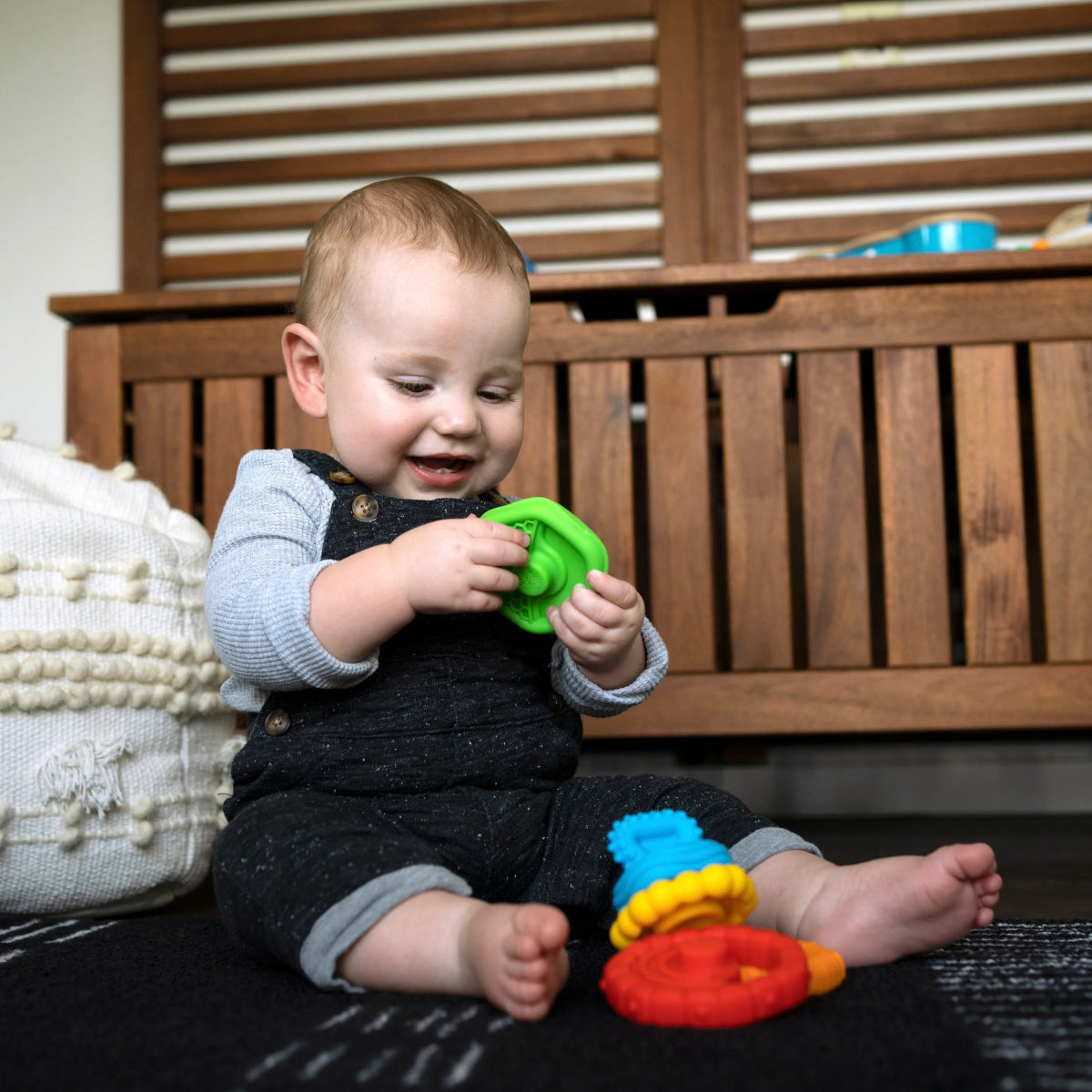 Stackable teether rings: green, blue, and red with raised grip textures