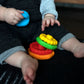 Teether rings in blue, green, yellow, red, and orange with textured grip bumps