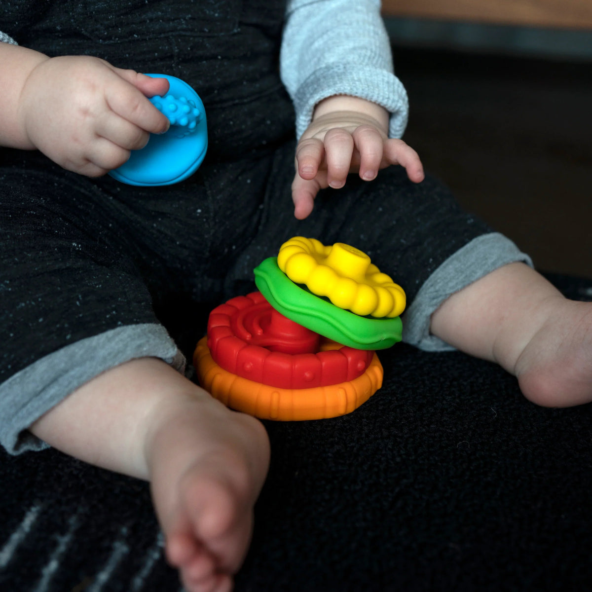 Teether rings in blue, green, yellow, red, and orange with textured grip bumps