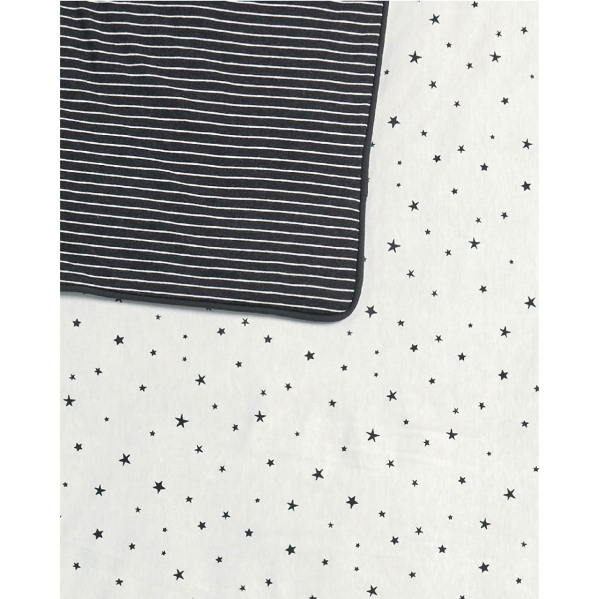 Reversible quilt with black-and-white horizontal stripes and a white star pattern