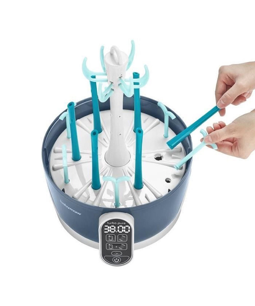 Steam sterilizer and dryer with teal bottle rack inside, white central stem, showing hands loading