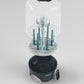 Steam sterilizer and dryer with clear dome cover, teal bottle rack, and open dark base