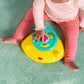 Child hands on yellow activity tray of teal activity walker while seated