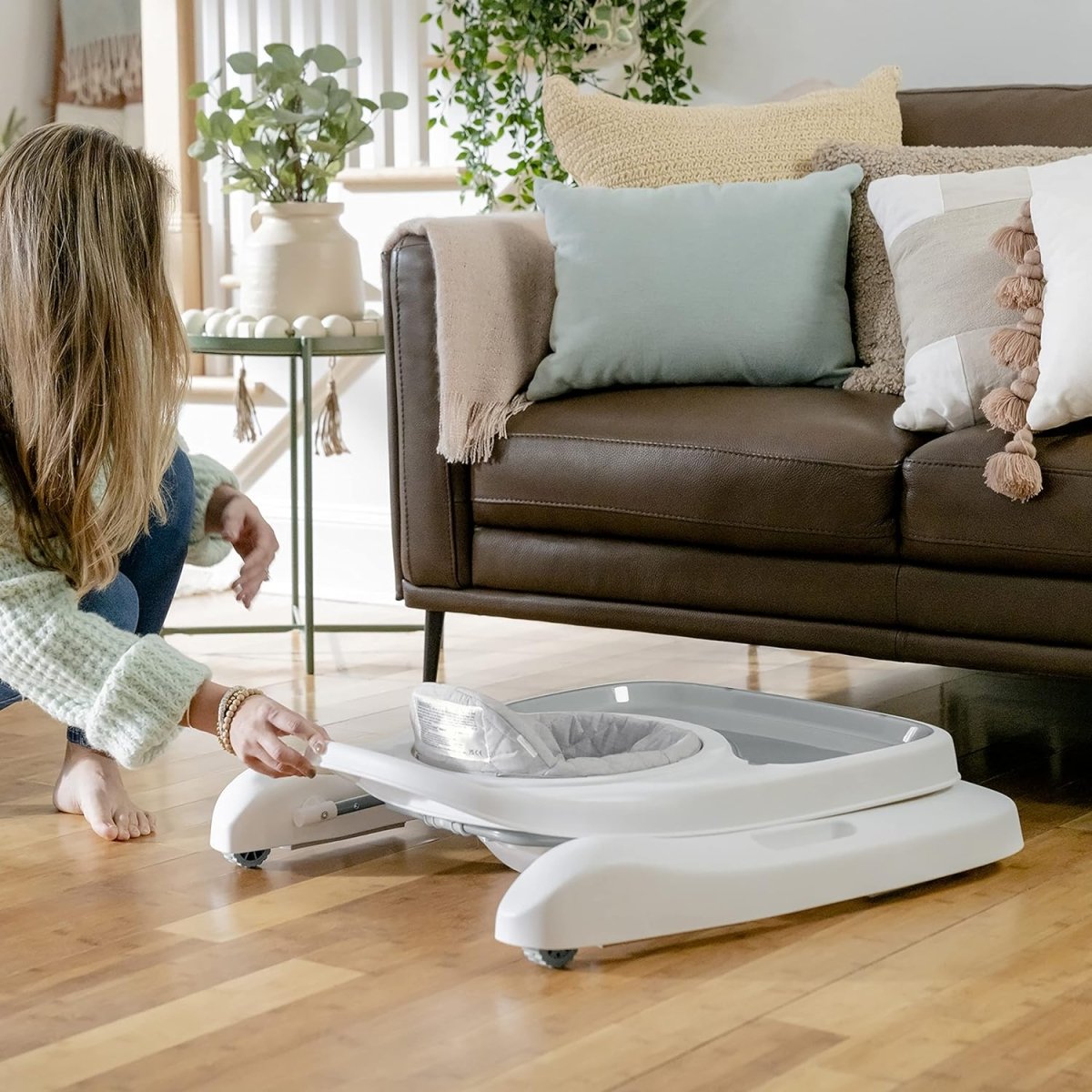 White foldable baby activity walker with gray seat and toy console