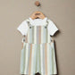 Striped dungaree romper over white T-shirt, vertical pastel stripes with button straps